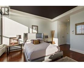 A bedroom with a large bed and a window.