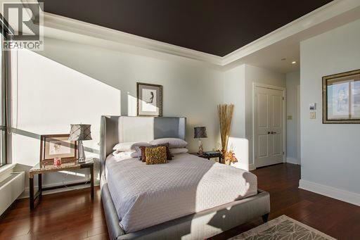 A bedroom with a large bed and a window.