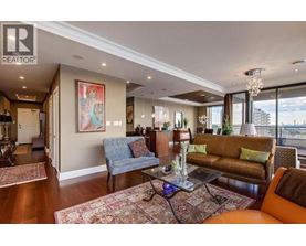 A living room with a blue couch and a brown couch.