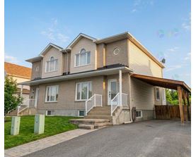 A two-story house with a garage on the right side.