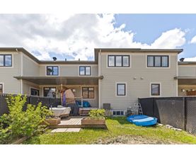 A residential building with a blue inflatable pool in the yard.