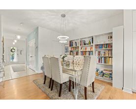 A dining room with a table set for four.