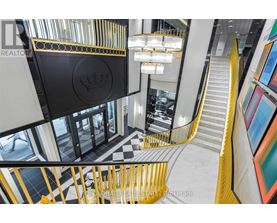 A staircase with a yellow railing and a black and white checkered floor.