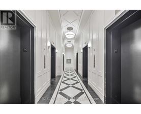 A hallway with doors on both sides and a checkered floor.
