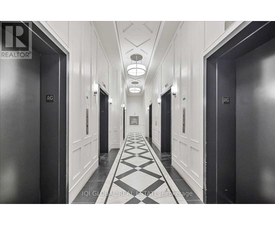 A hallway with doors on both sides and a checkered floor.