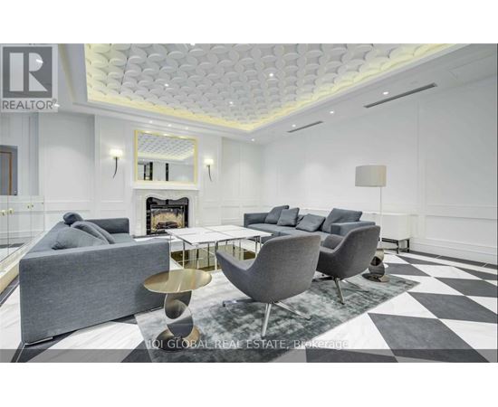A modern living room with a grey sofa, a coffee table, and a fireplace.