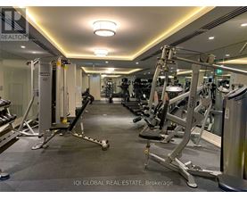A gym with a variety of equipment including treadmills, weights, and exercise machines.