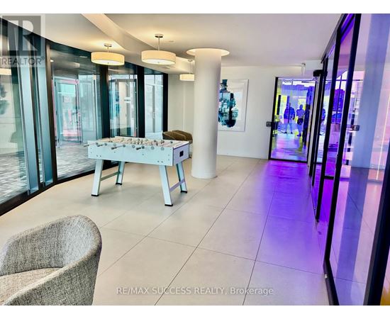 A modern living room with a white sofa and a glass table.