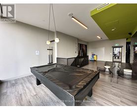 A modern bedroom with a large bed and a green accent wall.
