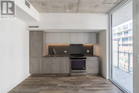 A modern kitchen with a stove top oven and a microwave.