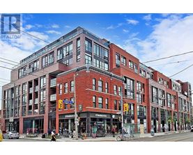 A large red brick building with a Starbucks on the ground floor.