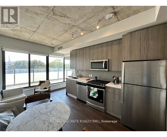 A modern kitchen with stainless steel appliances and a large window.