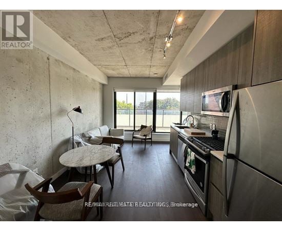 A kitchen with a table and chairs in front of a window.