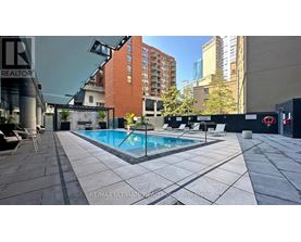 A swimming pool surrounded by a tiled patio area.