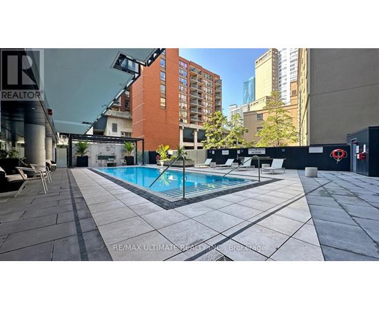 A swimming pool surrounded by a tiled patio area.