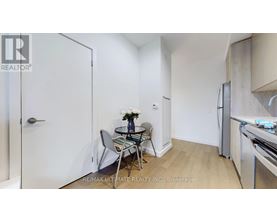 A small dining area with a glass table and chairs.