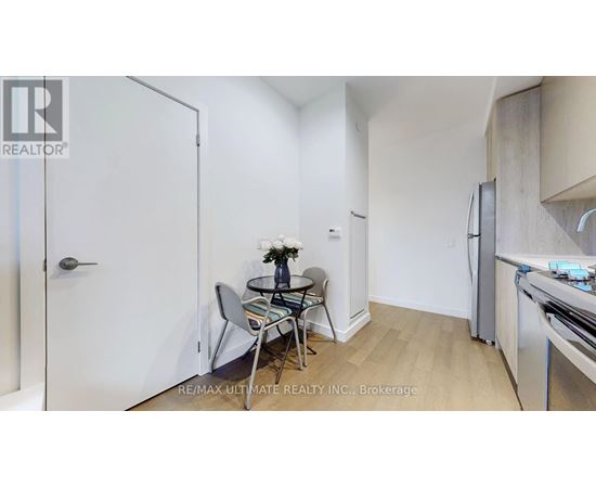A small dining area with a glass table and chairs.