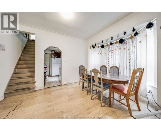 A dining room with a wooden table and chairs.