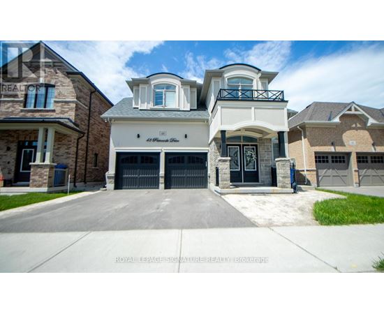 A large, two-story house with a garage is shown in the image.