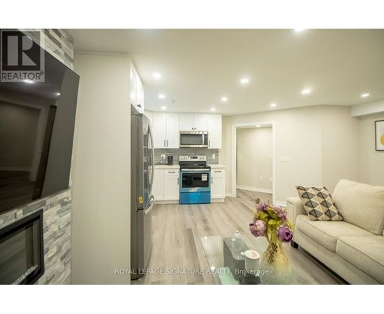 A modern kitchen with a glass table and a couch in the living room.