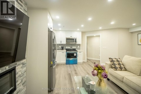 A modern kitchen with a glass table and a couch in the living room.