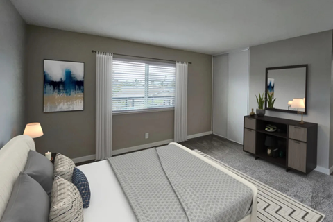 A bedroom with a large bed and a painting on the wall.