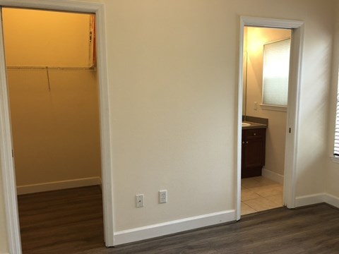A room with a white wall and a wooden floor.