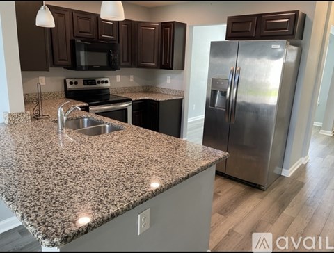 A kitchen with granite countertops and stainless steel appliances.