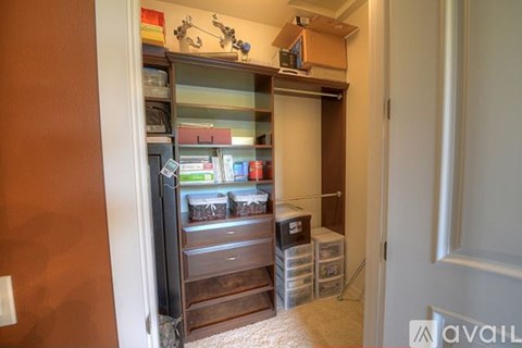A kitchen pantry with a wooden cabinet and a drawer.