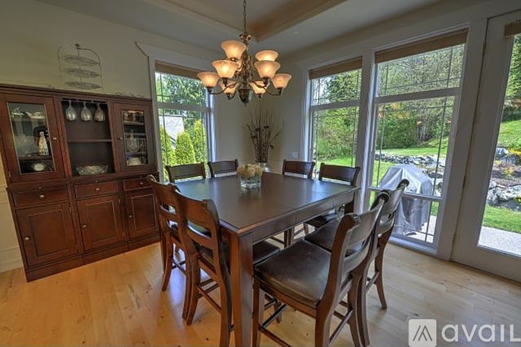 A dining room with a wooden table and chairs.