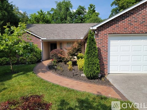 A house with a brick exterior and a white garage door.