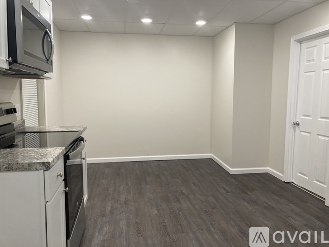 A kitchen area with a microwave, oven, and cabinets.