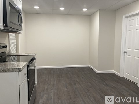 A kitchen area with a microwave, oven, and cabinets.