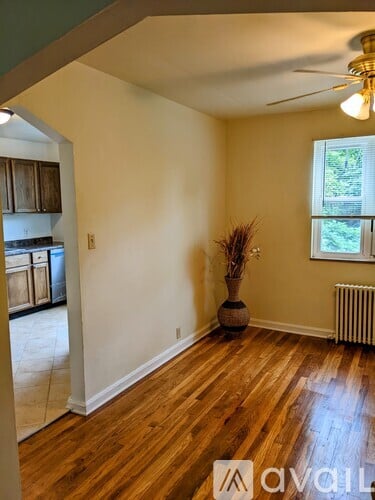 A room with wooden floors and a ceiling fan.