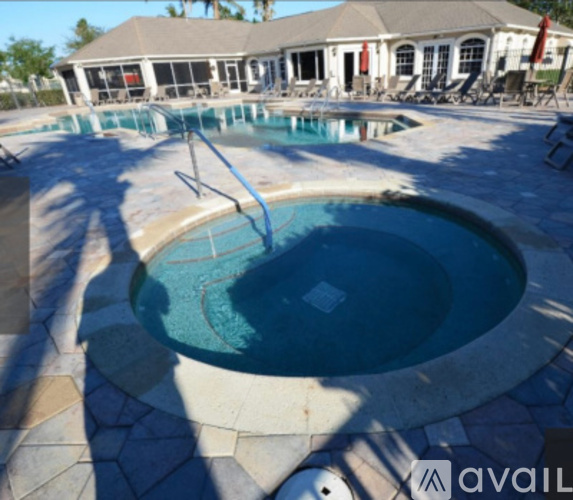 A pool with a slide in the middle of it.