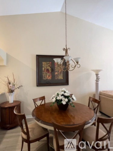 A dining room with a wooden table and chairs.