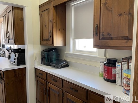 A kitchen with wooden cabinets and a white countertop.
