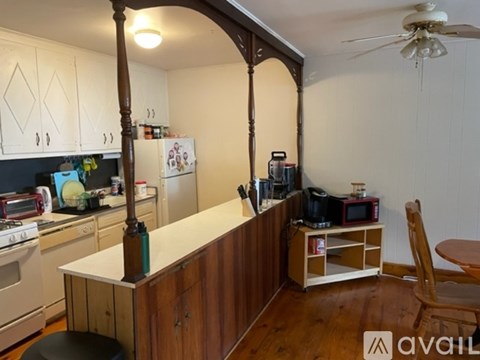 A kitchen with wooden cabinets and a white countertop.