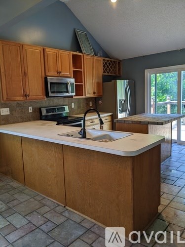 A kitchen with wooden cabinets and a white countertop.