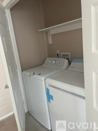 A white washing machine with a blue sticker on it.