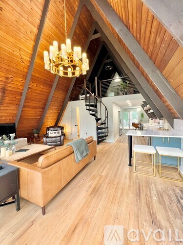 A living room with a couch and a chandelier.
