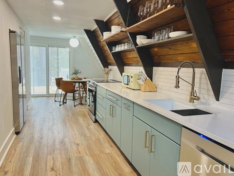 A kitchen with wooden floors and a white countertop.