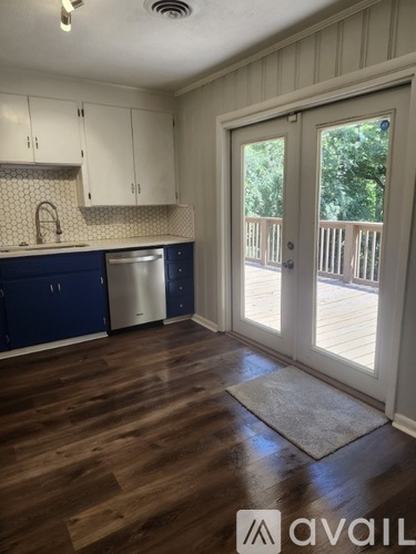 A kitchen with blue cabinets and a white fridge.