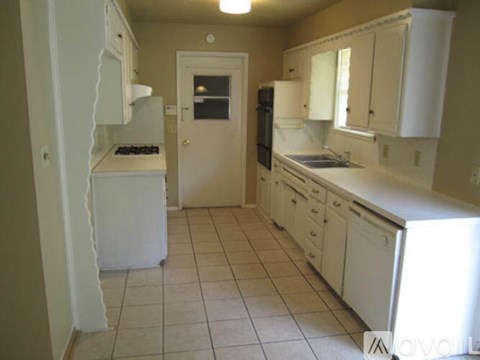 A kitchen with white appliances and cabinets.