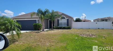 A house with a garage door and a driveway.