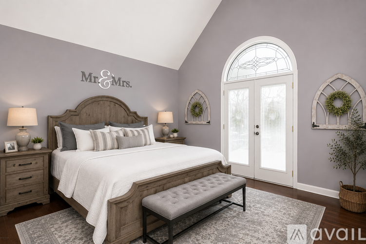 A bedroom with a large bed and a window with a view.