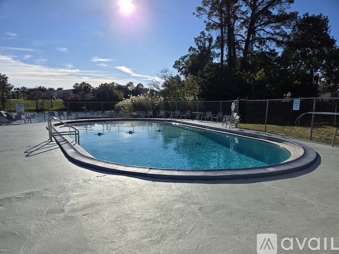 A round above ground pool with a metal fence around it.