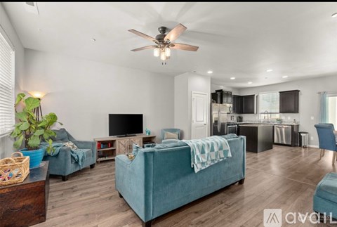 A living room with a blue couch and a television.