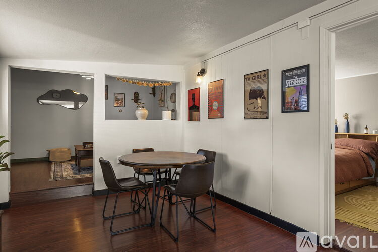 A dining room with a table and chairs.
