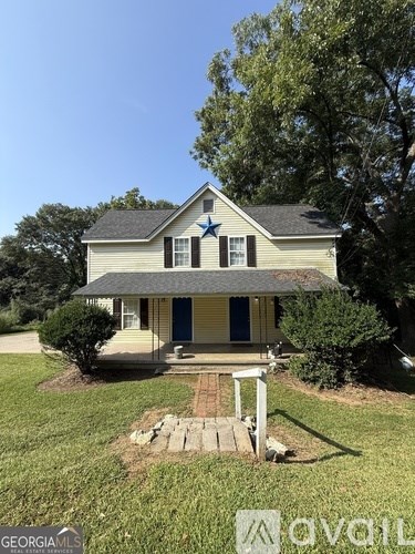 A house with a blue door and a porch.